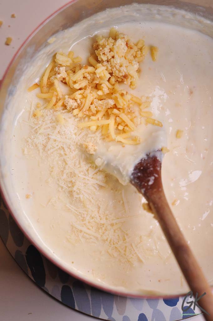 Cauliflower & Kale macaroni cheese adding the cheese
